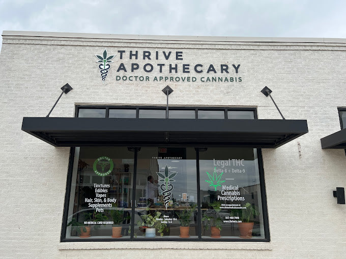 Thrive Apothecary staff member assisting a customer at the Fort Worth CBD store, providing expert advice on cannabis products.